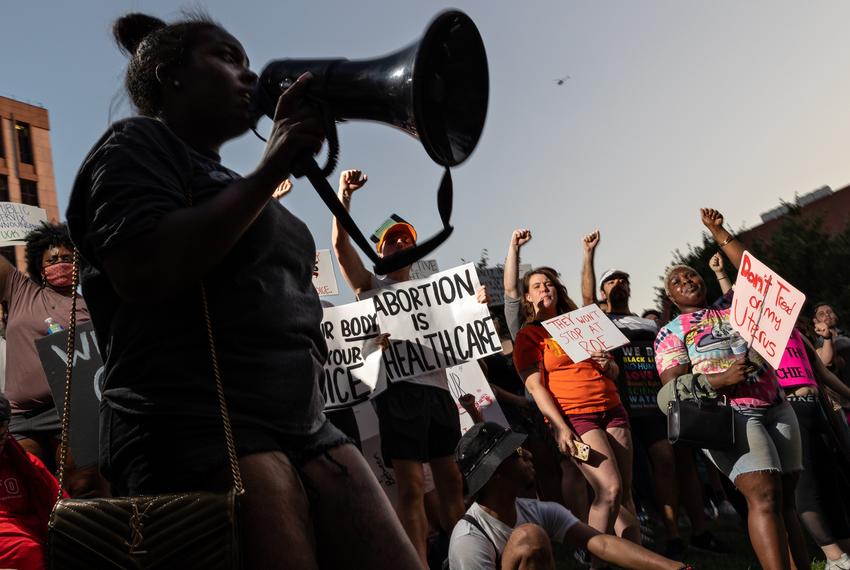 Attendees hold up their fists after a march against the overturning of Roe v. Wade, which virtually bans abortion in the state of Texas, on June 24, 2022.